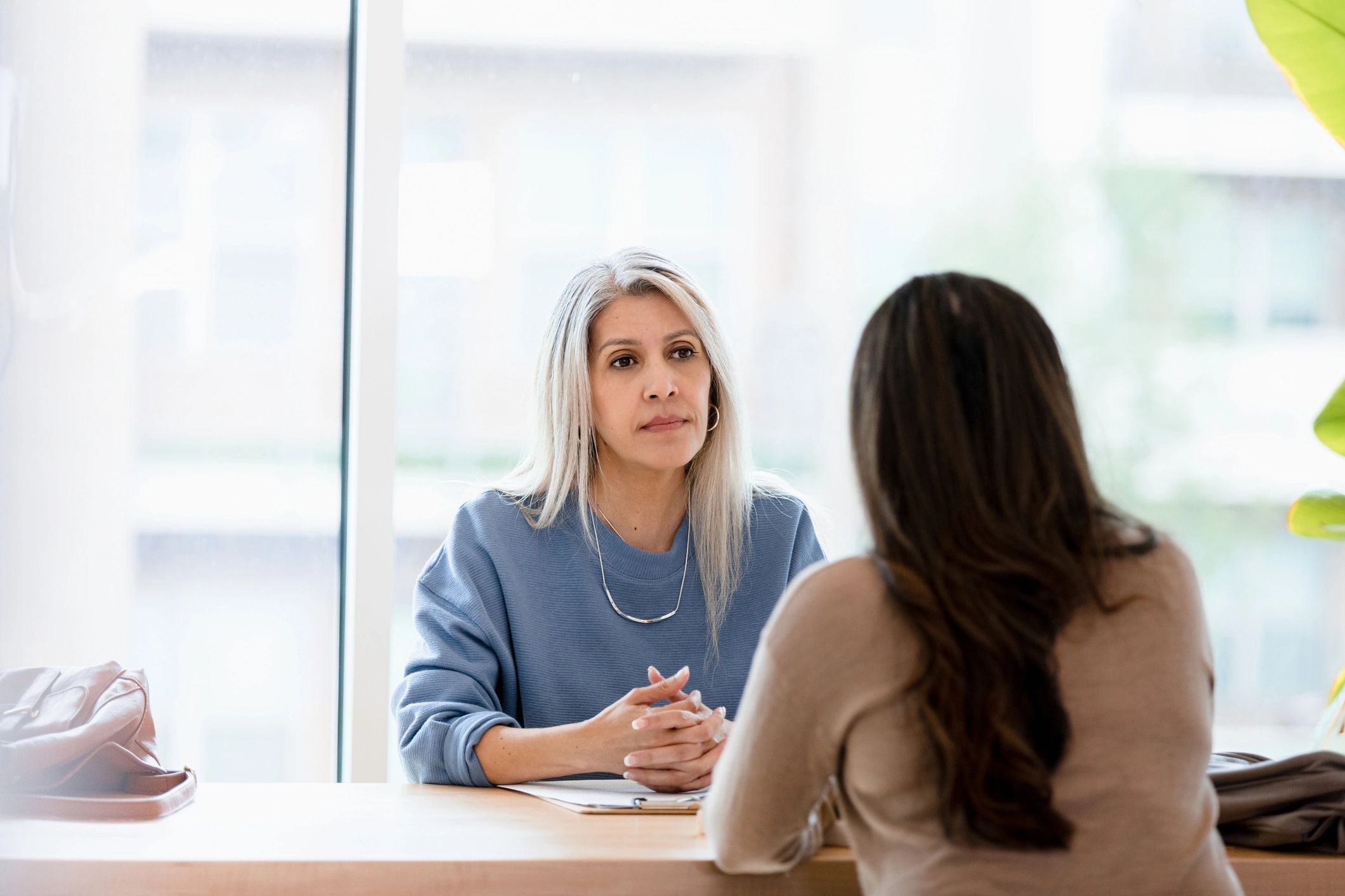 Insurance advisor meeting with a client in a private office setting