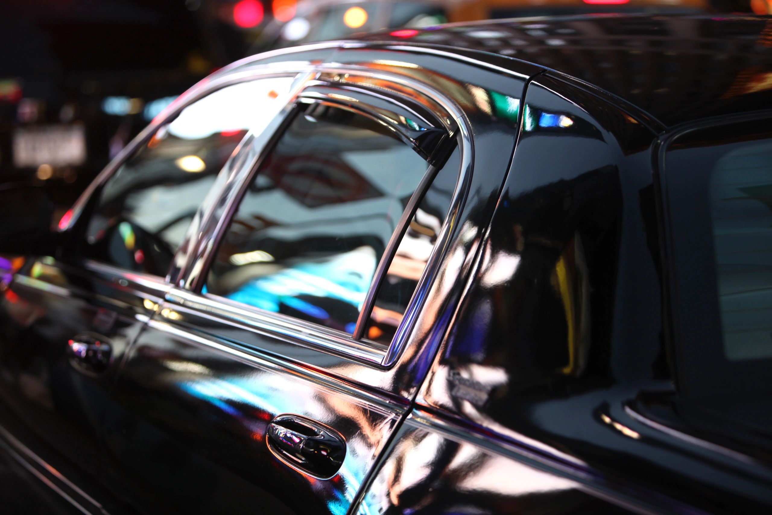 Close-up reflection on a luxury vehicle window representing data privacy and discretion